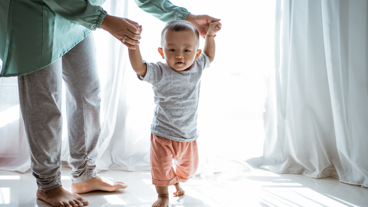 First Year Calendar for NICU Families baby walking orange pants